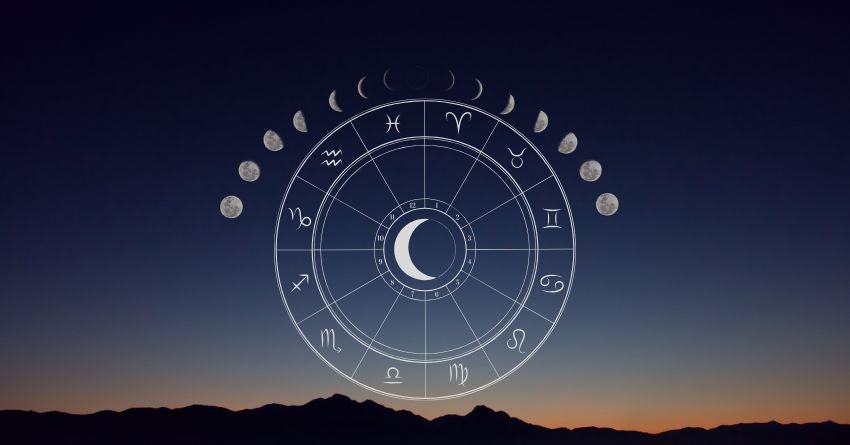 Crescent moon surrounded by zodiac symbols above a dark horizon under a deep blue night sky