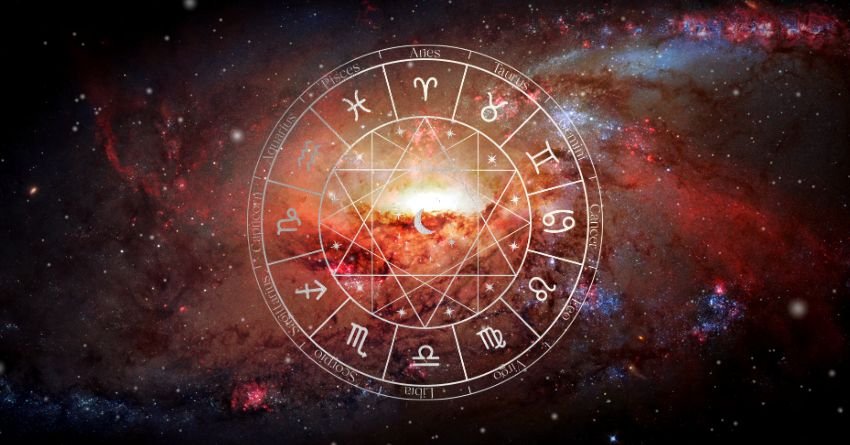 Glowing zodiac wheel surrounded by warm orange and red cosmic light on a dark celestial background