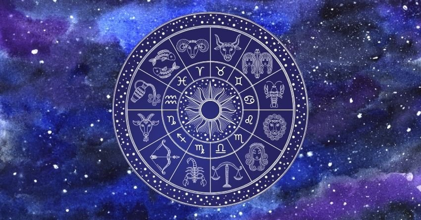 Glowing blue zodiac wheel with astrological symbols against a dreamy purple cosmic background