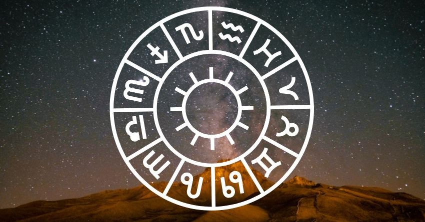 Glowing white zodiac wheel with astrological symbols above a dark landscape and dramatic sky