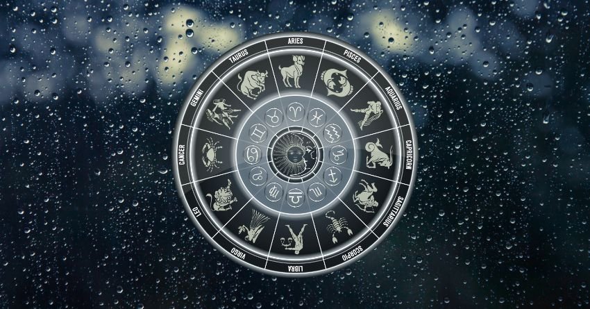Glowing silver zodiac wheel with astrological symbols surrounded by dark blue cosmic energy