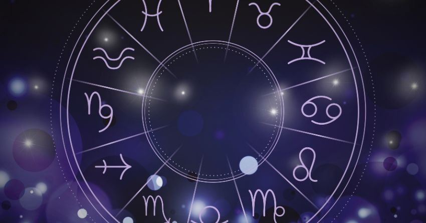 Glowing purple zodiac wheel with astrological symbols and bright celestial lights on a dark cosmic background