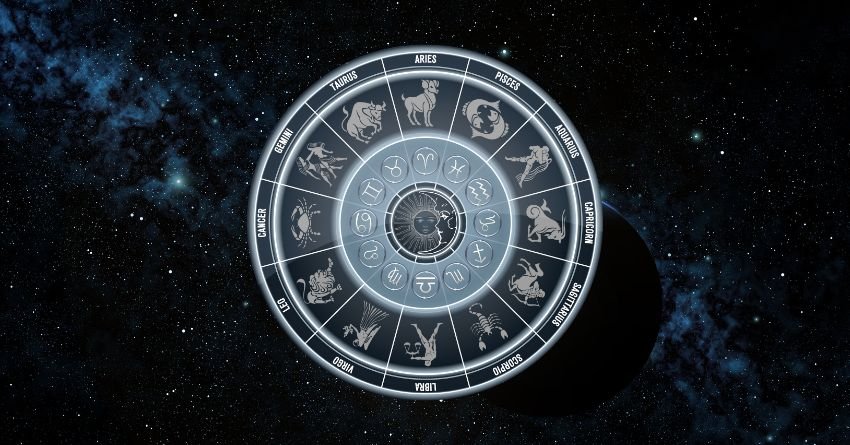 Glowing silver zodiac wheel with astrological symbols on a dark cosmic background