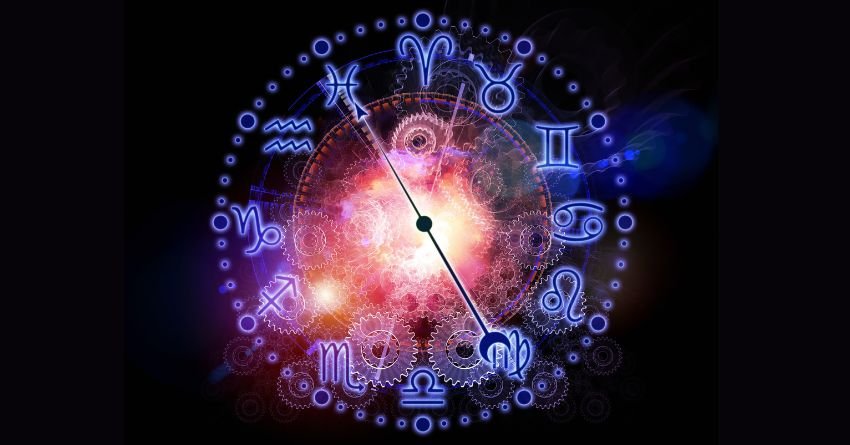 Colorful zodiac wheel glowing with blue, red, and purple cosmic energy on a dark background